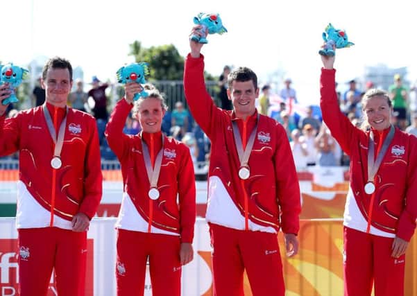 England's Alistair Brownlee (left) Jessica Learmonth,  Jonathan Brownlee and Vicky Holland celebrate taking silver during the Mixed Team Relay Triathlon. Picture: Danny Lawson/PA