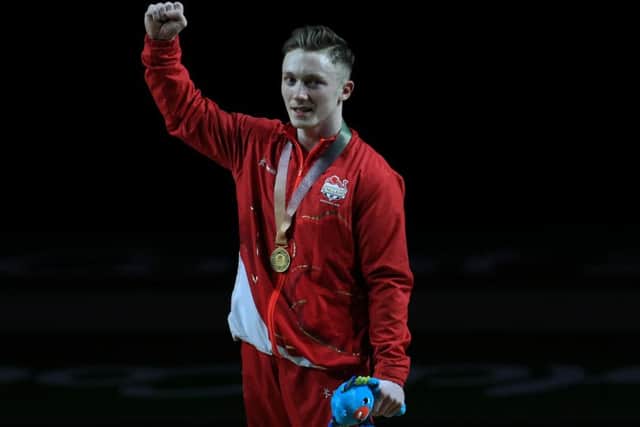 England's Nile Wilson celebrates winning a gold medal in the Men's Individual All-Round Final with coach Ben Collie at the Coomera Indoor Sports Centre during day three of the 2018 Commonwealth Games in the Gold Coast, Australia. (Pictures: Mike Egerton/PA Wire)