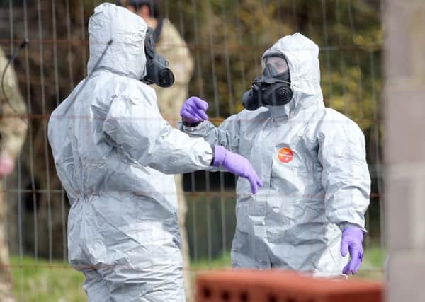 Soldiers in protective clothing investigating the nerve agent attack against Russian double agent Sergei Skripal.