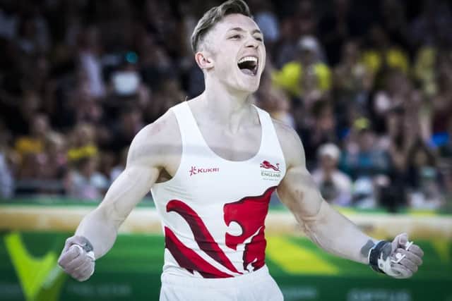 Golden boy: Nile Wilson celebrates following his routine on the men's horizontal bar .