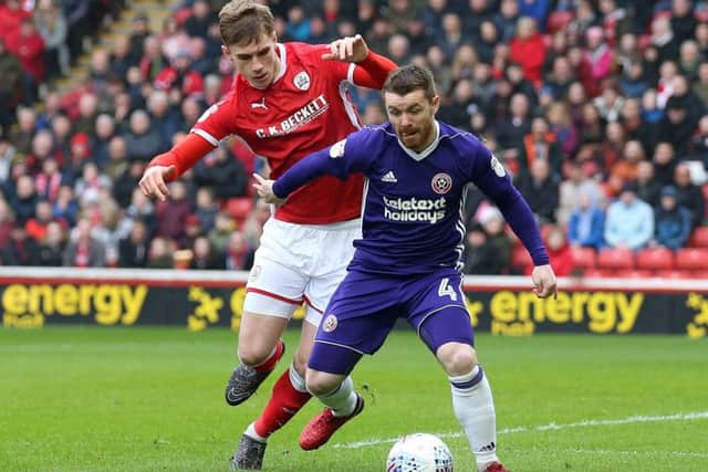 Sheffield United's John Fleck is hassled by Barnsley's Liam Lindsay during Saturday's match at Oakwell (Picture: Simon Bellis/Sportimage).