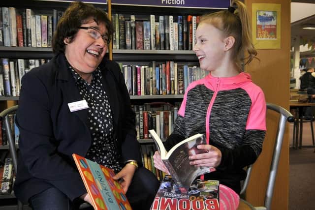 Trustee Lesley Newton chats to regular library user Abbie Vasey, 10. (Richard Ponter).