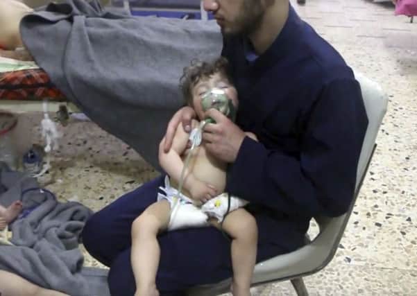 This image made from video released by the Syrian Civil Defense White Helmets, which has been authenticated based on its contents and other AP reporting, shows a medical worker giving toddlers oxygen through respirators following an alleged poison gas attack in the opposition-held town of Douma, in eastern Ghouta, near Damascus, Syria.
