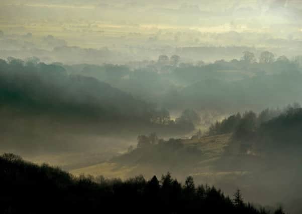 Mist lingers between the hills seen from the White Horse on the Hambleton Hills looking towards Oldstead and Byland Abbey on a cold winters morning. PIC: Tony Johnson