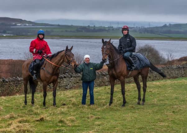 Sue Smith is pictured with her two Grand National runners. On the left is Delusionofgrandeur, with her assistant trainer Ryan Clavin in the saddle, while I Just Know (Sam Coltherd) is on the right.