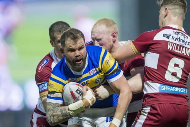 Leeds's Adam Cuthbertson is tackled by Wigan's Tony Clubb, Liam Farrell & George Williams. Picture: Allan McKenzie/SWpix.com