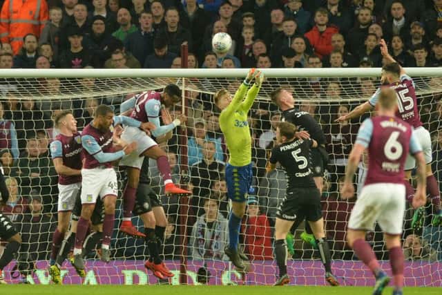 Leeds' young goalkeeper Bailey Peacock-Farrell punches clear at Villa Park.
 Picture: Bruce Rollinson