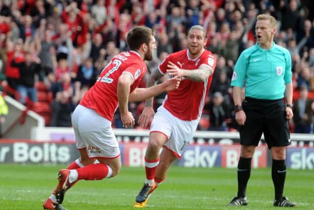 Barnsley's Gary Gardner wheels away with George Moncur after scoiring in the first half. (Picture: Tony Johnson)