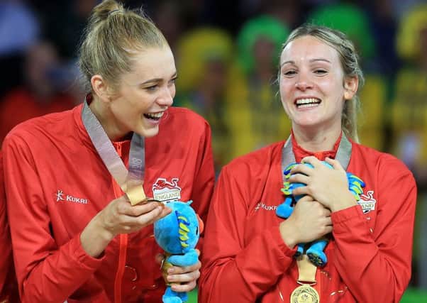 Helen Housby and Natalie Haythornthwaite celebrate with their gold medals.