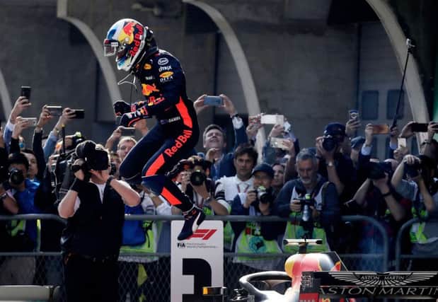 Red Bull driver Daniel Ricciardo of Australia jumps off his car after winning the Chinese Formula One Grand Prix
