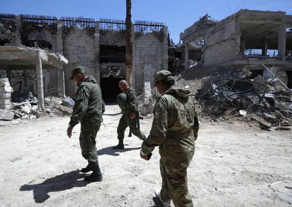Russian military police officers check a weapons factory left behind by members of the Army of Islam group, in the town of Douma, the site of a suspected chemical weapons attack, near Damascus, Syria.