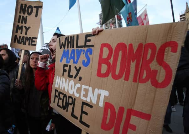 Protesters during a demonstration against military intervention in Syria in Parliament Square, London.
