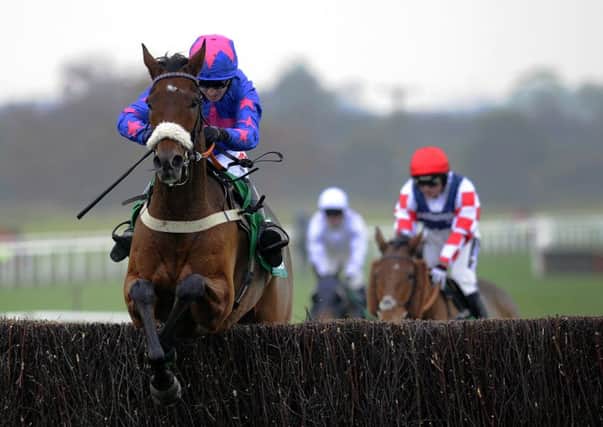 Paddy Brennan and Cue Card jump the final fence in the 2015 Charlie Hall Chase at Wetherby.