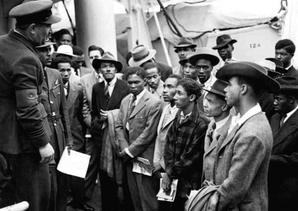 Jamaican immigrants being welcomed by RAF officials from the Colonial Office after the ex-troopship HMT "Empire Windrush" landed them at Tilbury in 1948.