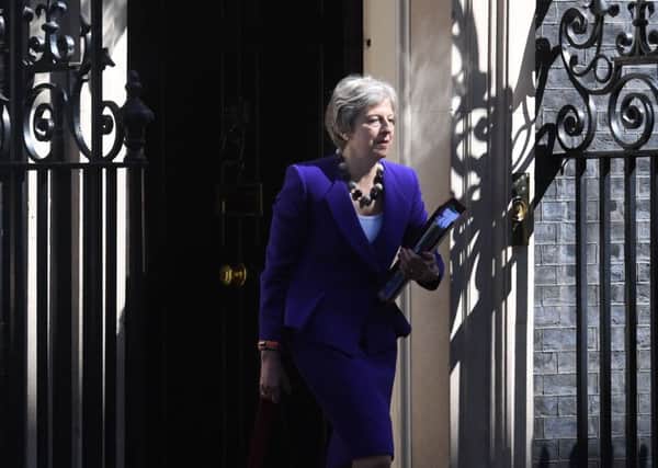 Theresa May leaving 10 Downing Street for PMQs on the anniversary of her fateful decision to call a snap election.