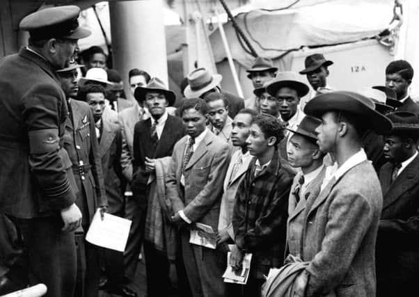 File photo 22/06/1948 of Jamaican immigrants welcomed by RAF officials from the Colonial Office after the ex-troopship  HMT 'Empire Windrush' landed them at Tilbury.