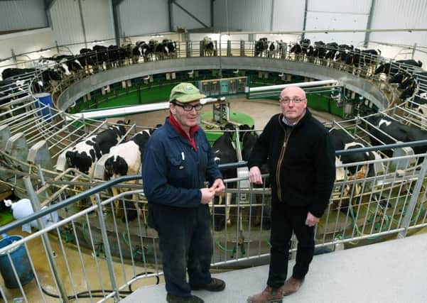 Electrical contractor Steven Dresser, who works specifically with farmers on all types of electrical work for farm buildings and new innovations. Pictured with dairy farmer John Banks, where Steven helped install in rotary milking parlour. Pictures by Jonathan Gawthorpe.