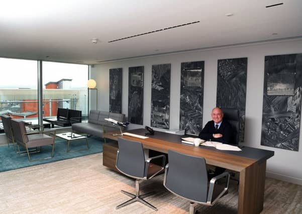 Steve in his office, which boasts a £30,000 Walter Knoll desk. The pictures behind are by a Polish arist and tell a story of football violence, reminiscent of the 1970s.