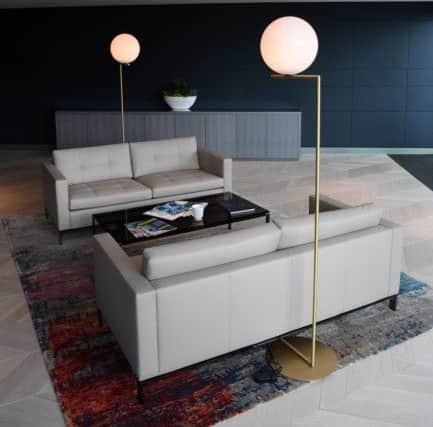 The reception/events space with rug and sofas by Knoll and lamps by Flos