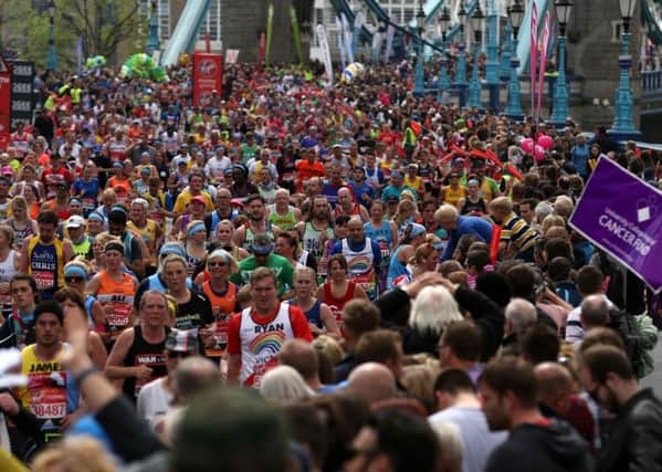 Runners make their way across Tower Bridge during last year's London Marathon.
