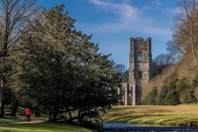 The vast Cistercian ruins of Fountains Abbey provide an impressive backdrop for a picnic