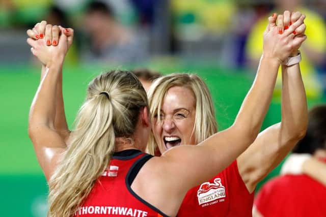 England's Natalie Haythornthwaite celebrates winning the Commonwealth Games gold medal match with coach Tracey Neville