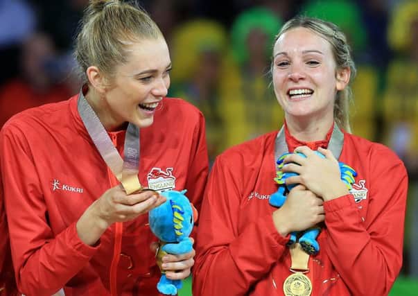 Helen Housby and Natalie Haythornthwaite, right, celebrate with their gold medals after winning the Women's Netball final against Australia, (Picture: Martin Rickett/PA Wire)