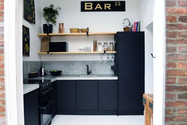 Chloe designed the kitchen, which includes joiner-made plywood units and open shelves plus a cut-price concrete worktop.