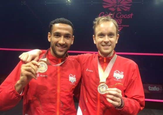 TEAMWORK: Celebrating bronze medal in the men's doubles with Declan James.