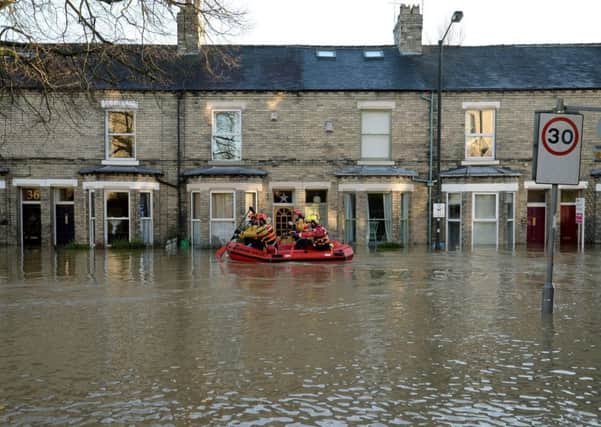 Members of a Mountain Rescue team paddle along Huntington Road in York, after the River Foss and Ouse burst their banks on Sunday December 27, 2015. Picture: Anna Gowthorpe/PA Wire