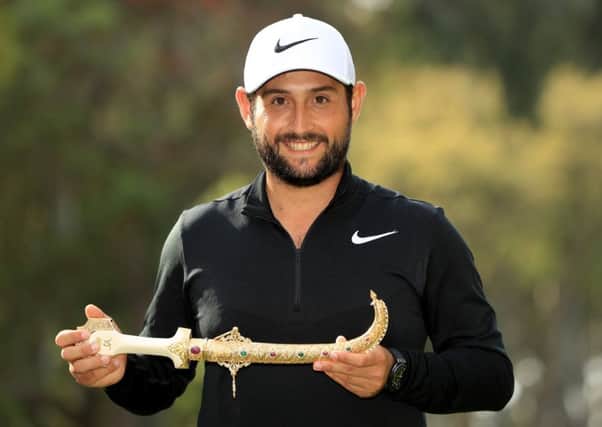 Alexander Levy of France celebrates with the winners trophy after the final round of the Trophee Hassan II in Morocco