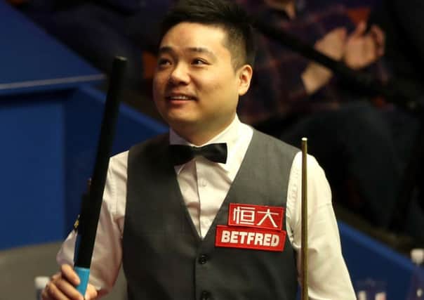 Ding Junhui celebrates beating Xiao Guodong at the Crucible (Picture: Simon Cooper/PA Wire).