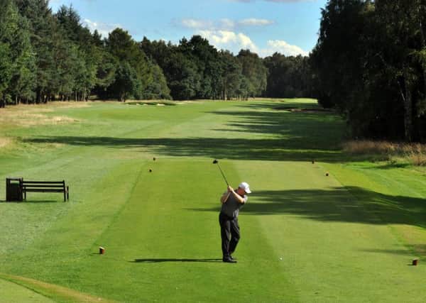 Gary Pearce, general manager at Fulford Golf Club, tees off at the sixth, one of the course's signature holes.