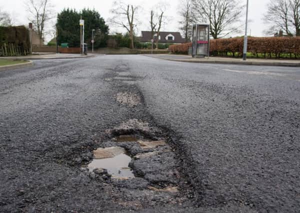 Should utility companies pay for pothole repairs?