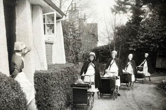 Four nurses pushing prams in single file along the driveway of the St Matthew's Hospital Nursery School, Buckinghamshire.