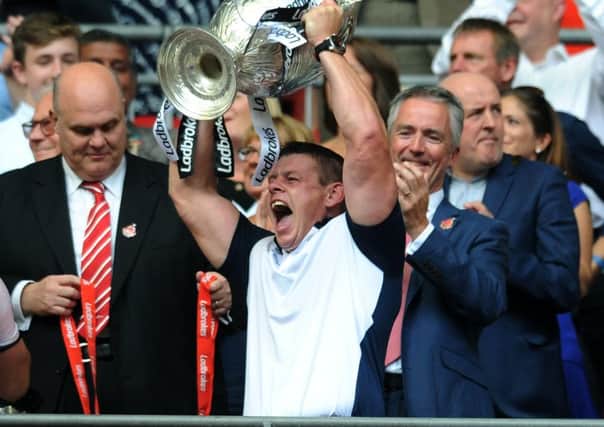 Hull's head coach Lee Radford lifts the cup.