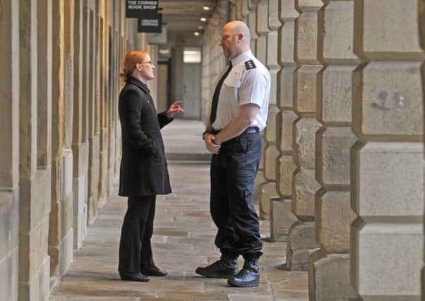 Holly Lynch MP with Chief Insp Nick Smart, Chair West Yorkshire Police Federation on a walkabout  in the Piece Hall, Halifax.