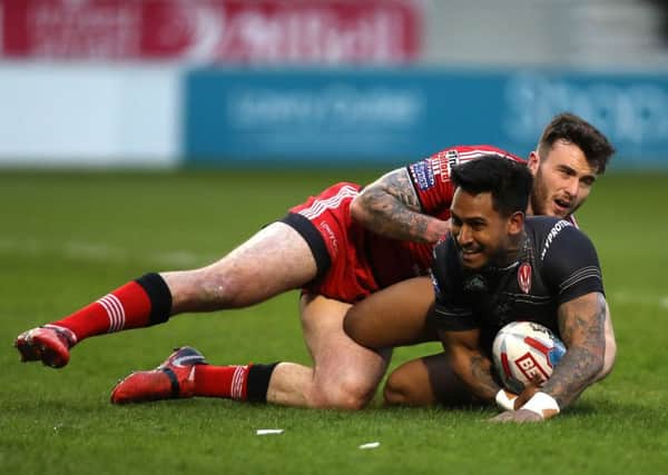 St Helens Ben Barba scores his side's third try of the game under pressure from Salford Red Devils' Jake Bibby.