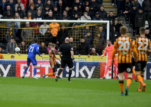 Stephen Kingsley, of Hull City, turns around alongside Craig Bryson, of Cardiff City and watches Cardiff score their second goal.  Picture James Hardisty.