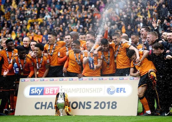 Wolverhampton Wanderers players celebrate with champagne and the Championship trophy after a 0-0 draw with Sheffield Wednesday.
