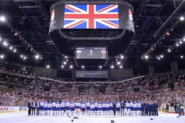 PRIDE: GB's players embrace each other as they listen to the national anthem being played after being presented with their gold medals. Picture: Dean Woolley.