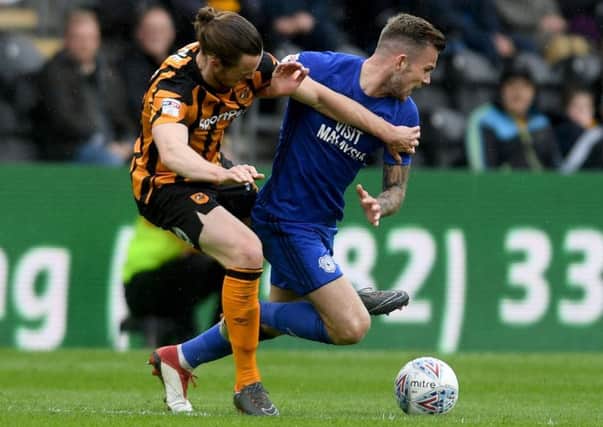 Battle: Will Keane, of Hull City, tackles Joe Ralls, of Cardiff City. Picture: James Hardisty
