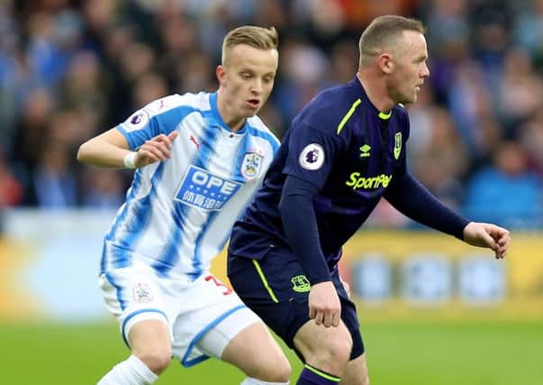 Huddersfield Town's Florent Hadergjonaj (left) and Everton's Wayne Rooney battle for the ball