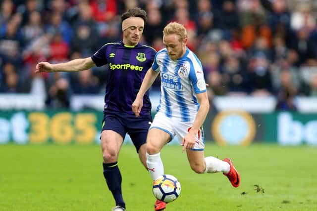 Everton's Leighton Baines (left) and Huddersfield Town's Alex Pritchard (right)