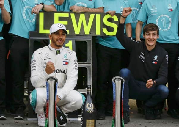 Mercedes driver Lewis Hamilton, of Britain, celebrates with his team after winning the Azerbaijan Formula One Grand Prix, at the city circuit, in Baku. (AP Photo/Luca Bruno)