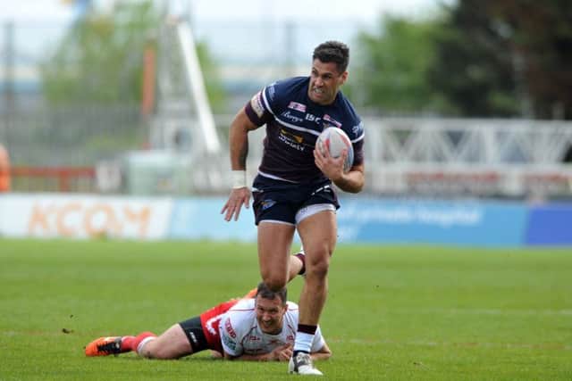 Rhinos Joel Moon breaks from Hull KR's Danny McGuire to score Leeds' first try. (Picture: Tony Johnson).