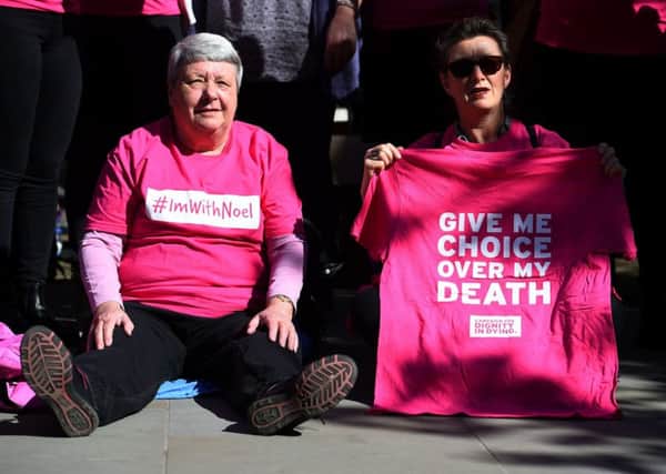 Activists from the Campaign for Dignity in Dying outside the Royal Courts of Justice in London, where motor neurone disease sufferer Noel Conway is to begin an Appeal Court challenge against a "blanket ban" on assisted dying. PIC: PA