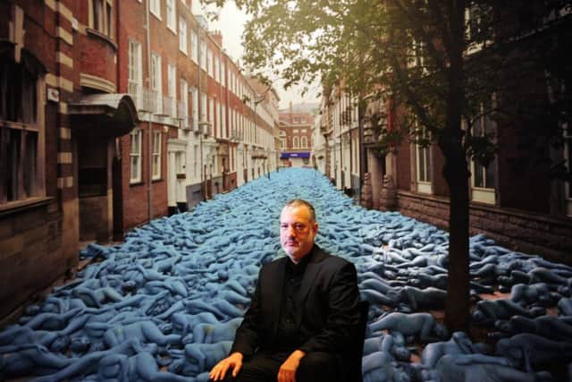 Artist Spencer Tunick pictured with one of his photographs,Sea of Hull. Picture by Simon Hulme