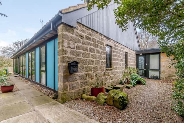 The house is stone-built with some timber cladding and features large ares of glazing