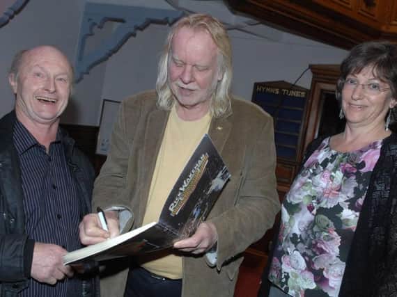 Rick Wakeman signs his autograph at Boston Spa Methodist Church for fans Steve and Racheal Bird. (Picture by Adrian Murray)